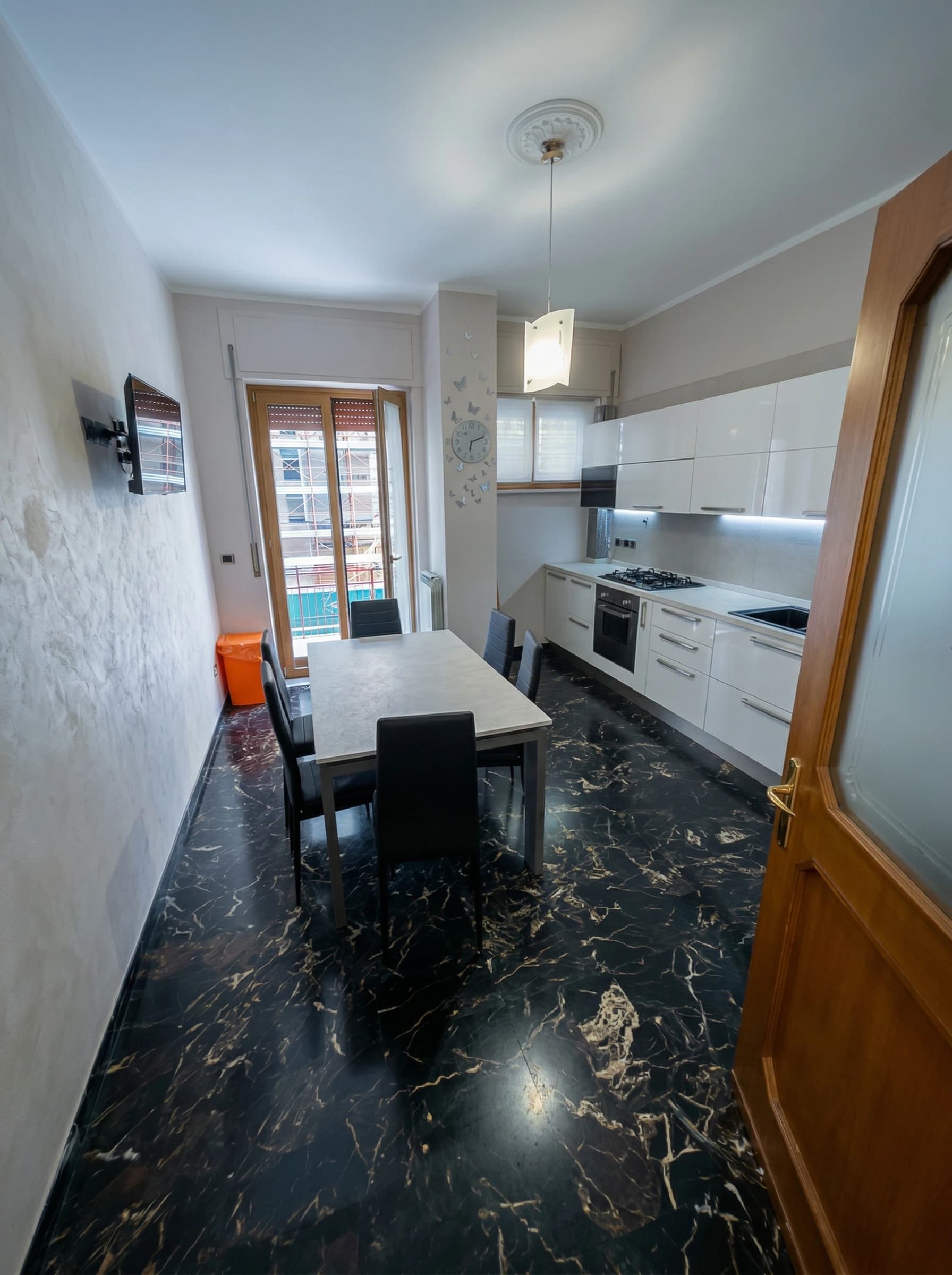 Modern kitchen with black marble floor