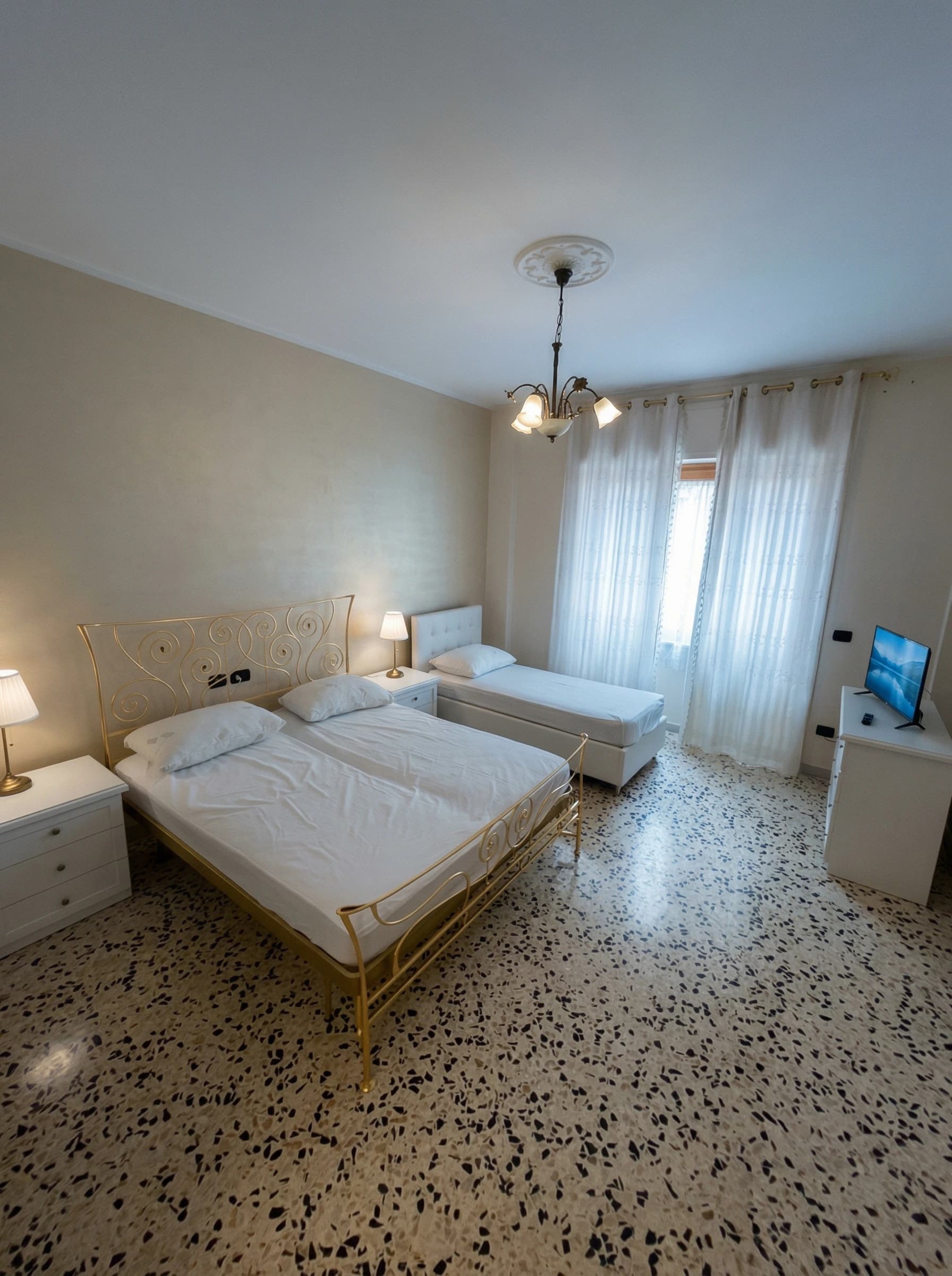 Bedroom with golden iron bed and single bed